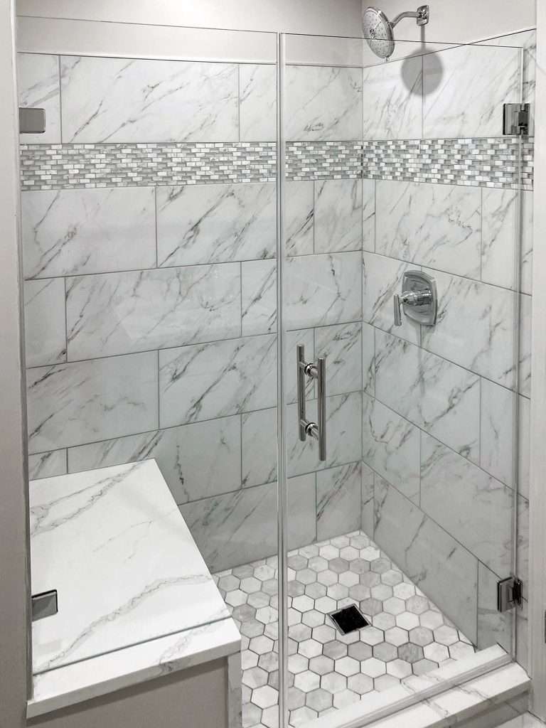 frameless shower doors with grey/white tiles