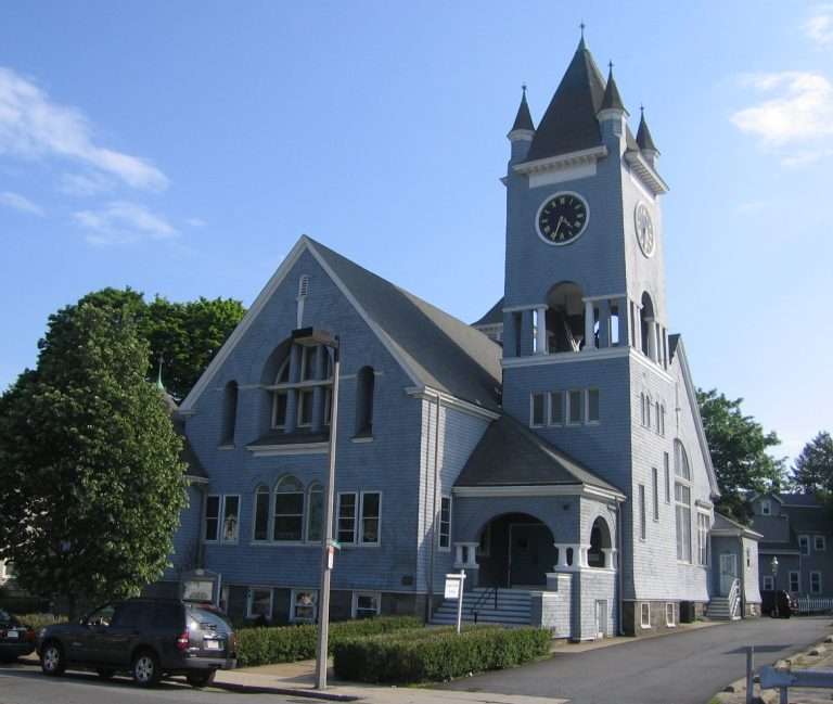 Historic gray church with tall clock tower