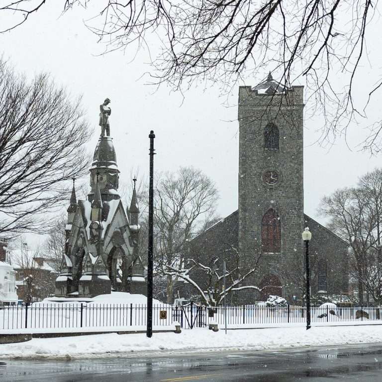 Snowy church and monument in winter scene