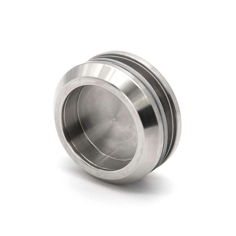 A shiny, round, metallic object with a recessed center and smooth edges, resembling a stainless steel cap or plug, is featured on a white background—an example from the IDEAL Knob selection.