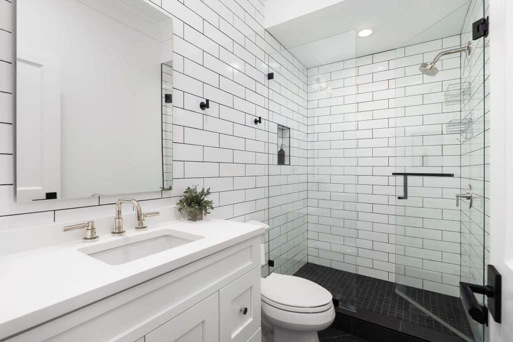 Modern white bathroom with glass shower enclosure