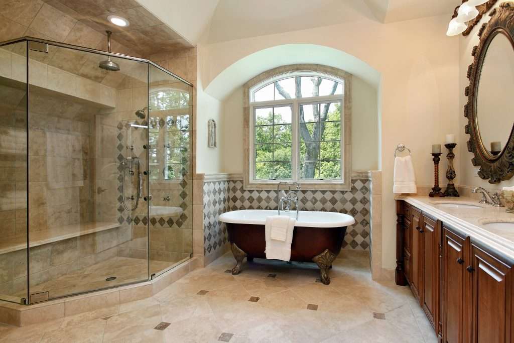 Luxury bathroom with glass shower and clawfoot tub