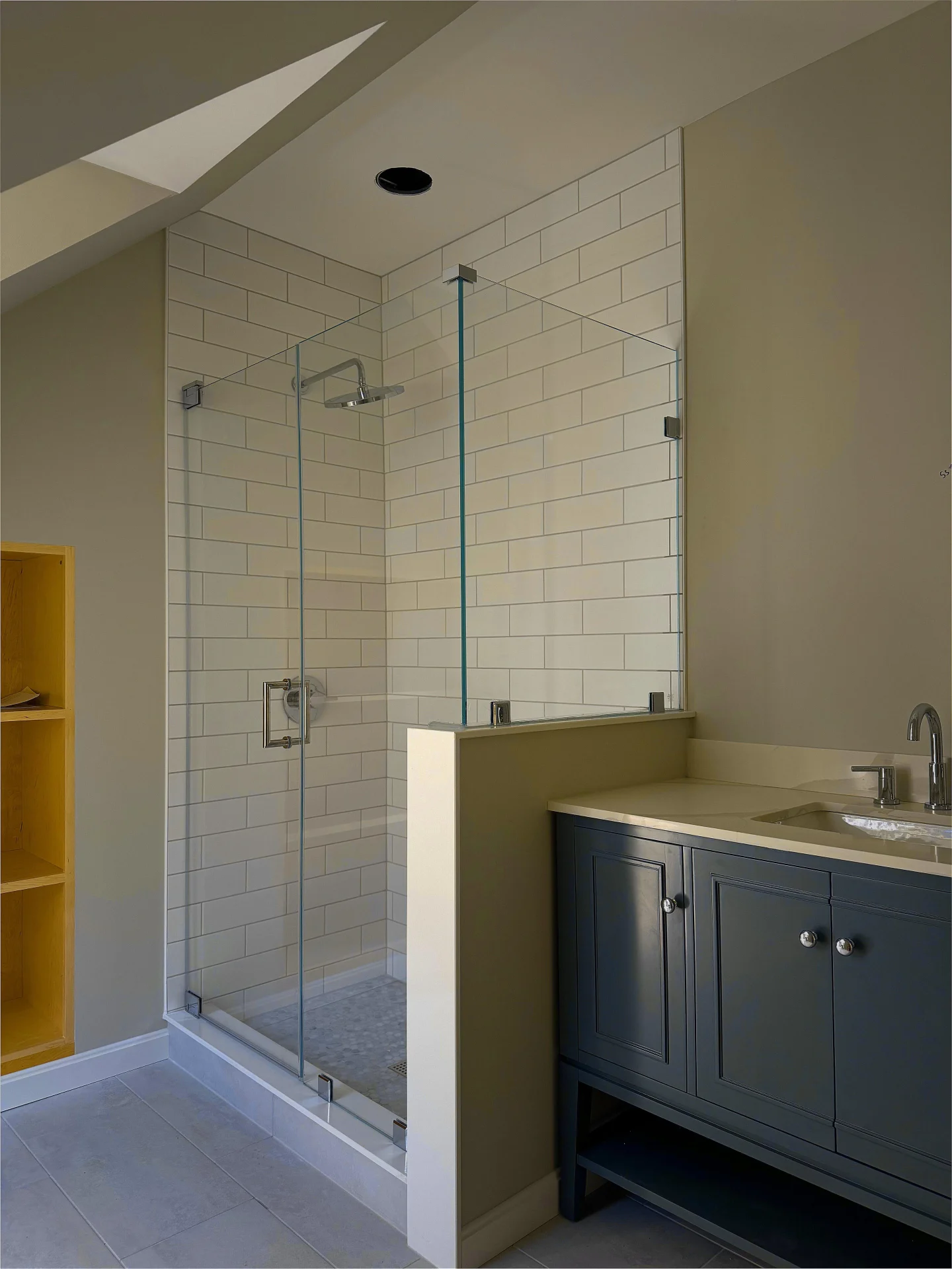 Frameless pivot shower door chrome hardware white subway tile Amherst NH