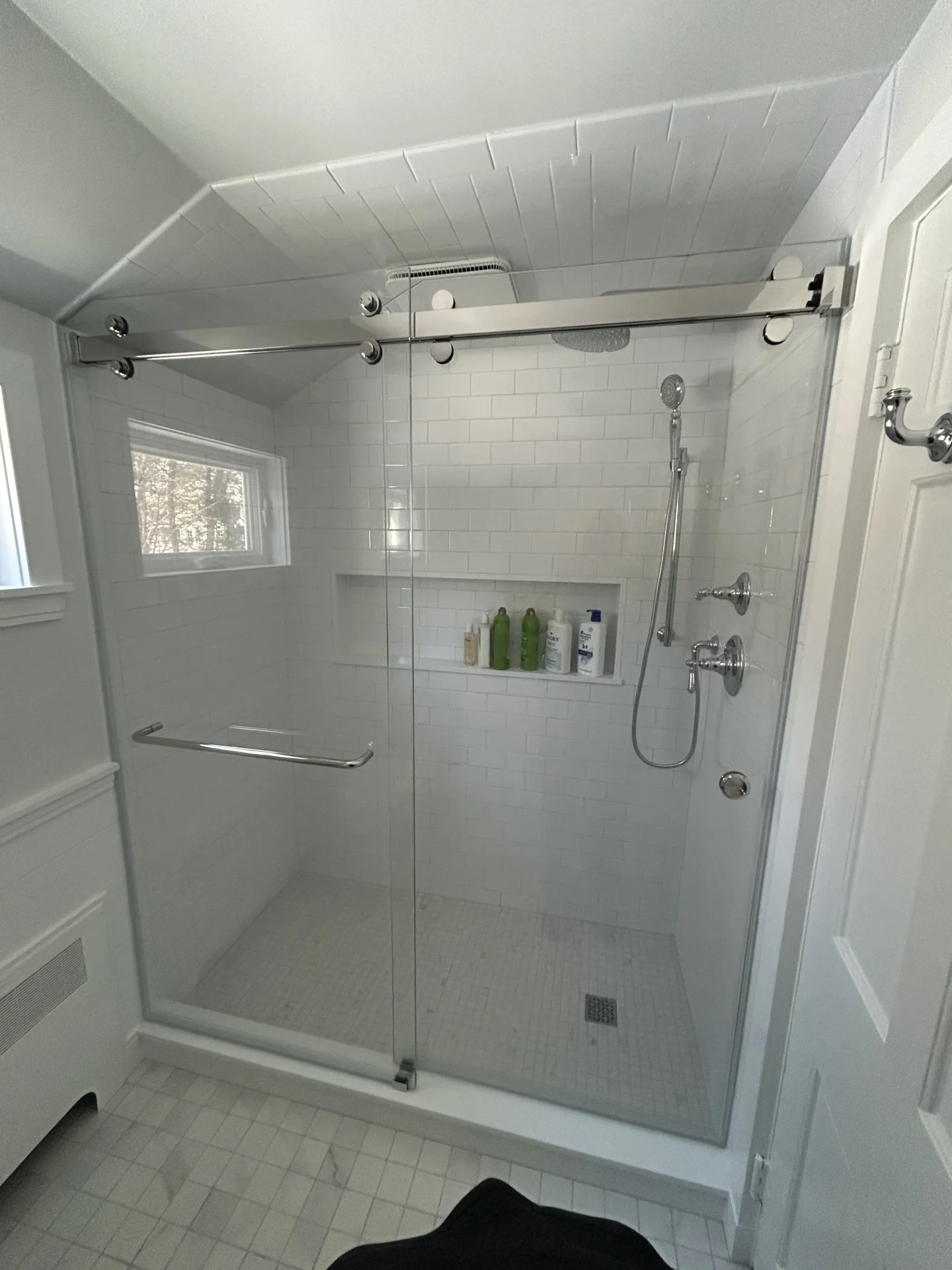 Sliding frameless shower enclosure chrome rail white subway tile Wellesley MA