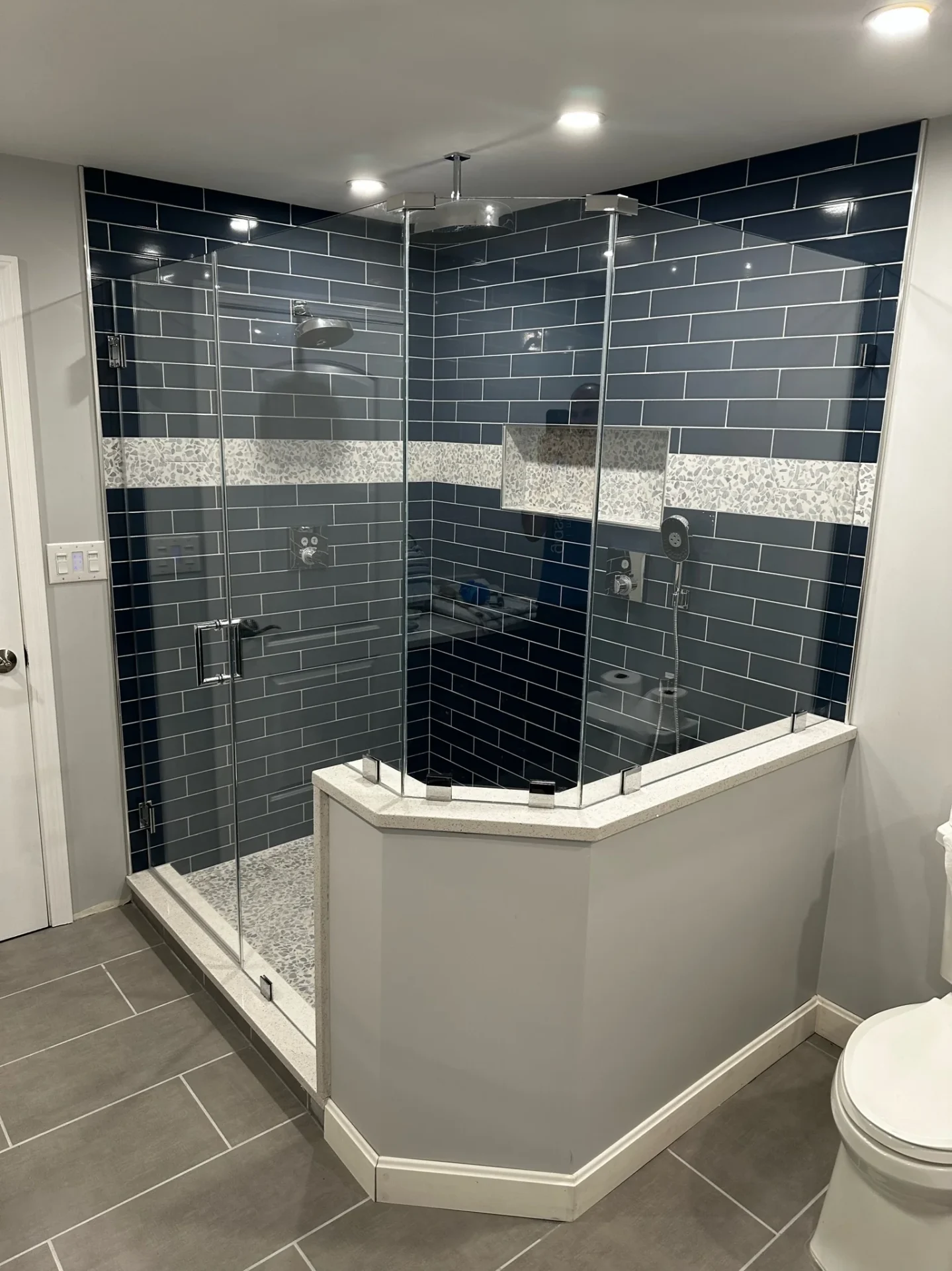 Frameless neo-angle shower enclosure chrome navy subway tile Maynard MA