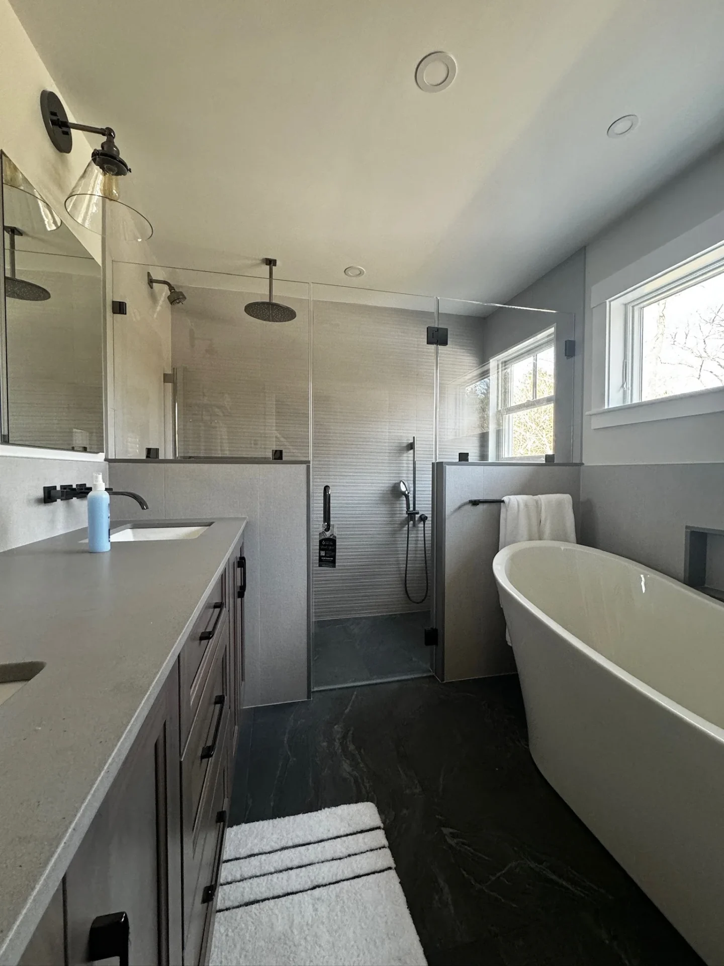 frameless inline shower door matte black hardware freestanding tub Newburyport MA