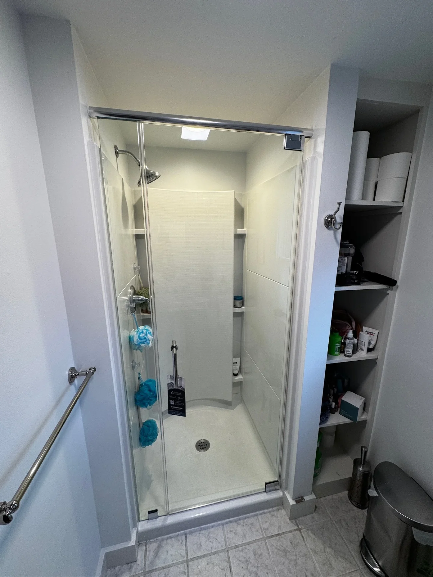 frameless pivot shower door chrome hardware white acrylic surround Boston MA