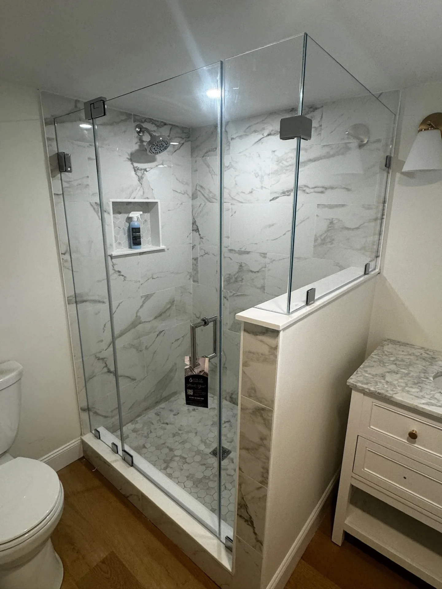 frameless corner shower door chrome hardware white marble tile Milton MA