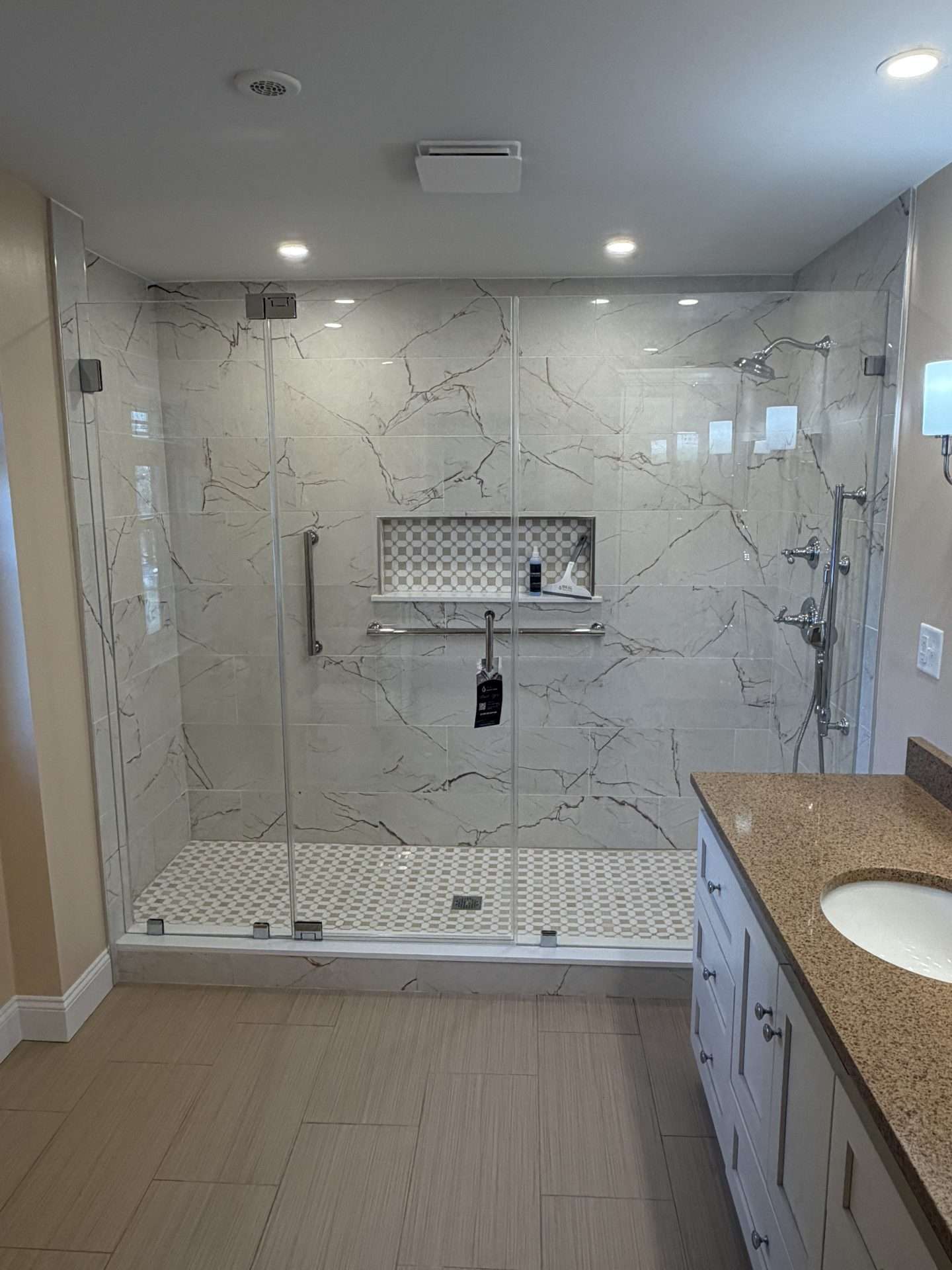 Luxury marble slab frameless shower door with chrome hardware and built-in niche, Gloucester MA