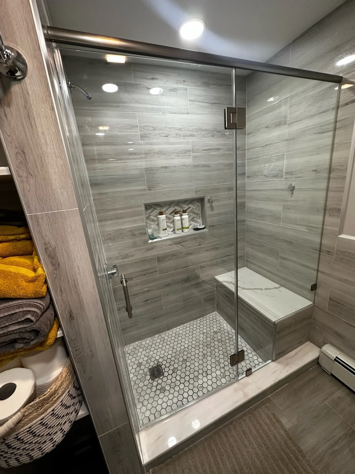 Frameless shower enclosure gray wood-look porcelain hex floor Peabody MA