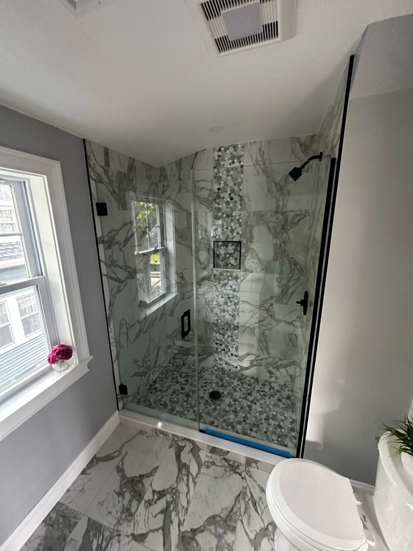 Frameless corner shower matte black hardware Calacatta marble penny tile Saugus MA