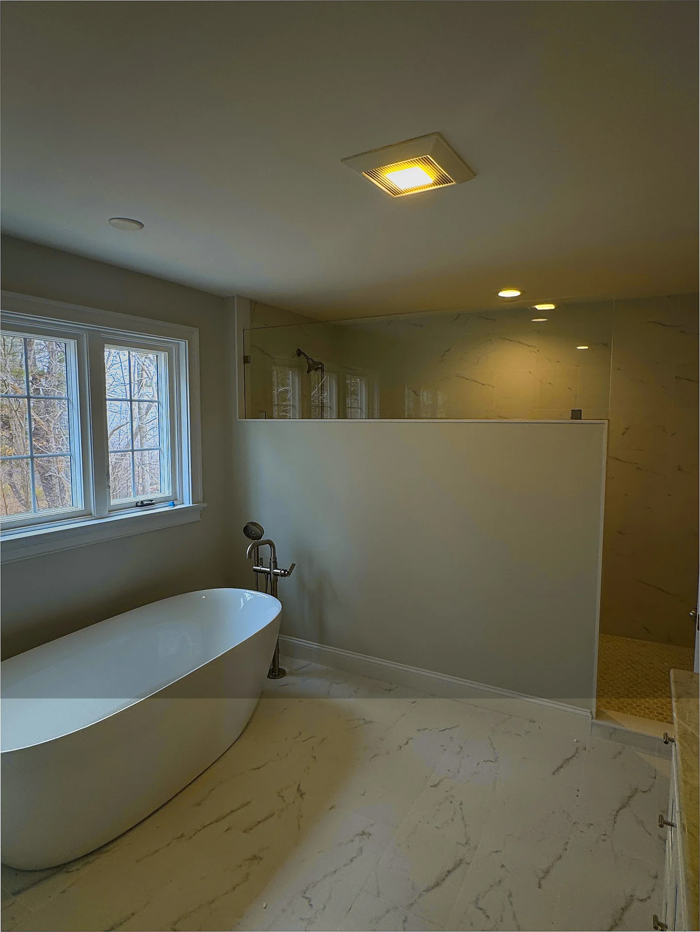 Open walk-in shower frameless glass partition marble tile freestanding tub Rowley MA