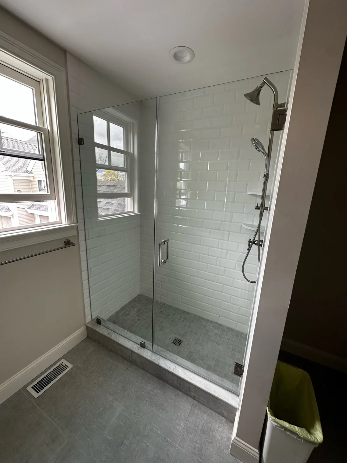 Hinged frameless shower door chrome hardware subway tile Reading MA