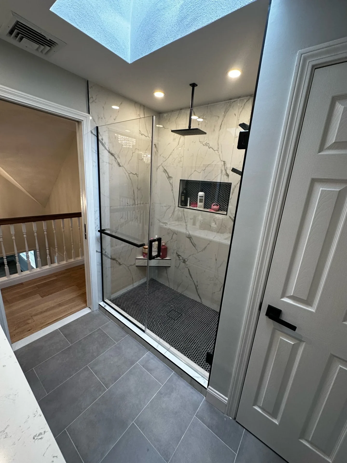 Hinged frameless door matte black hardware marble slab Danvers MA