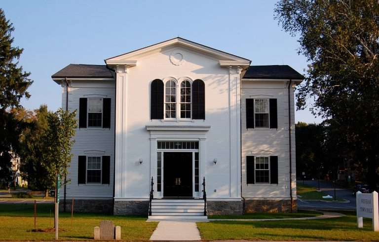 White colonial-style town hall with black shutters
