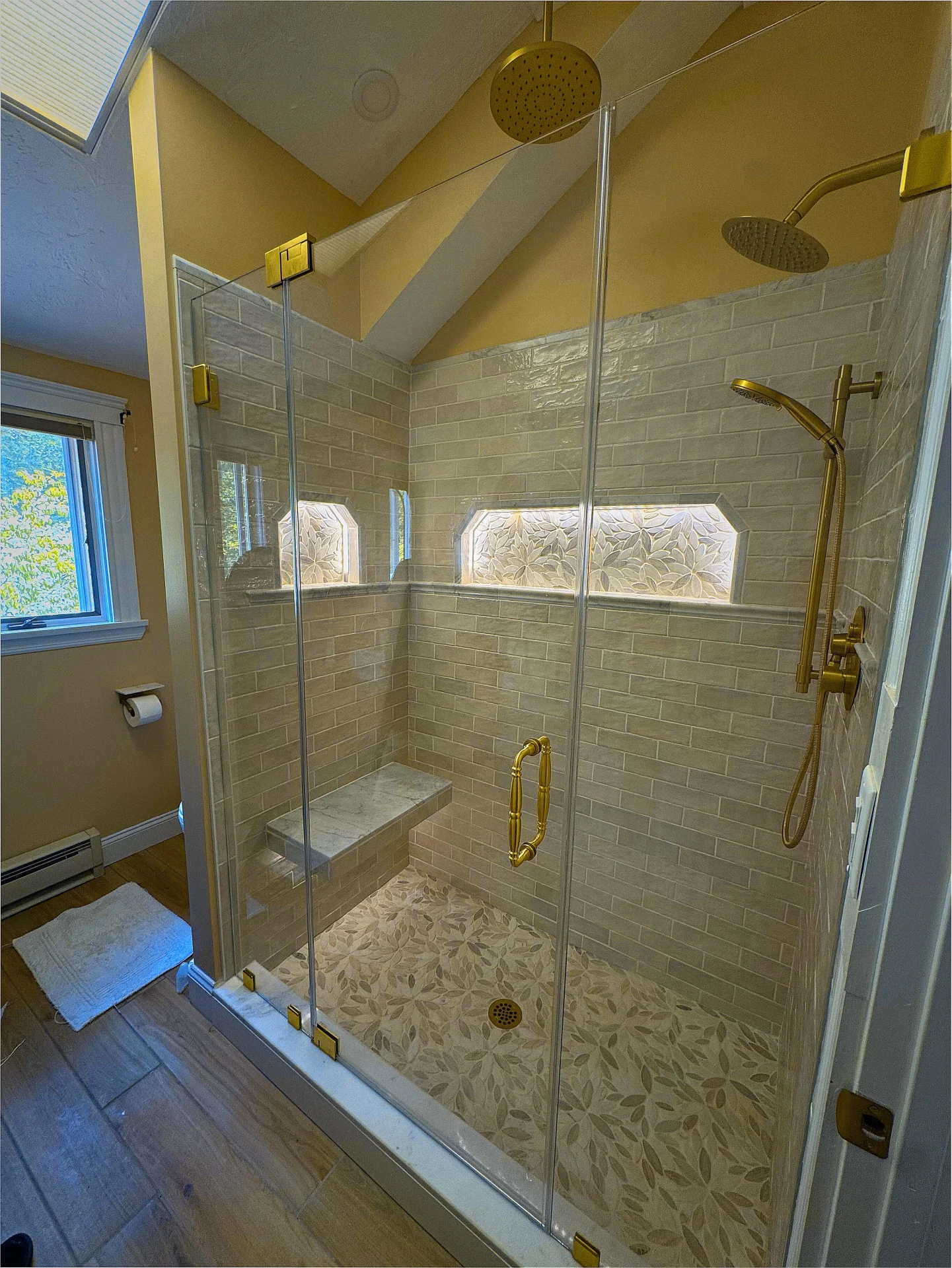 frameless pivot shower door polished gold hardware botanical leaf mosaic floor North Reading MA