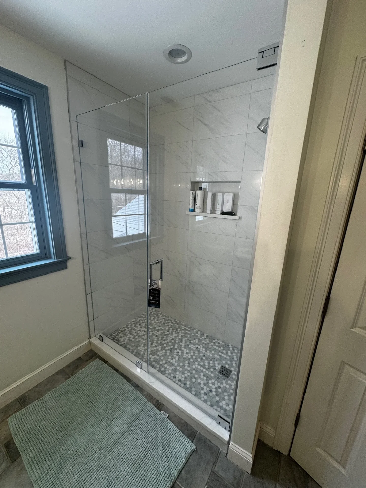 Frameless corner shower chrome hardware white marble tile Hamilton MA