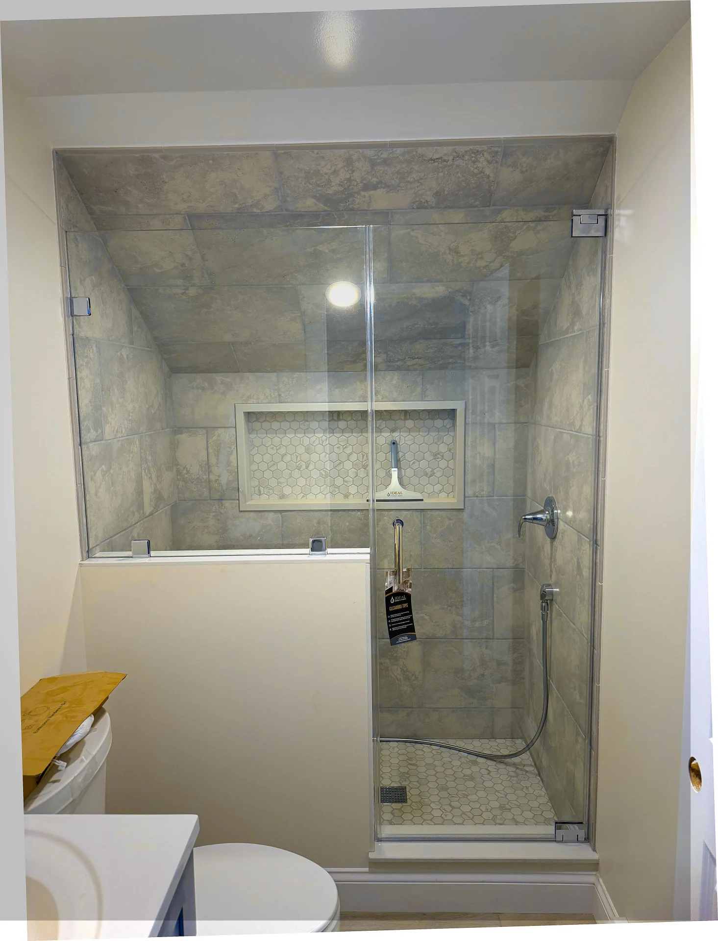 Frameless glass shower chrome hardware earthy stone tile Danvers MA