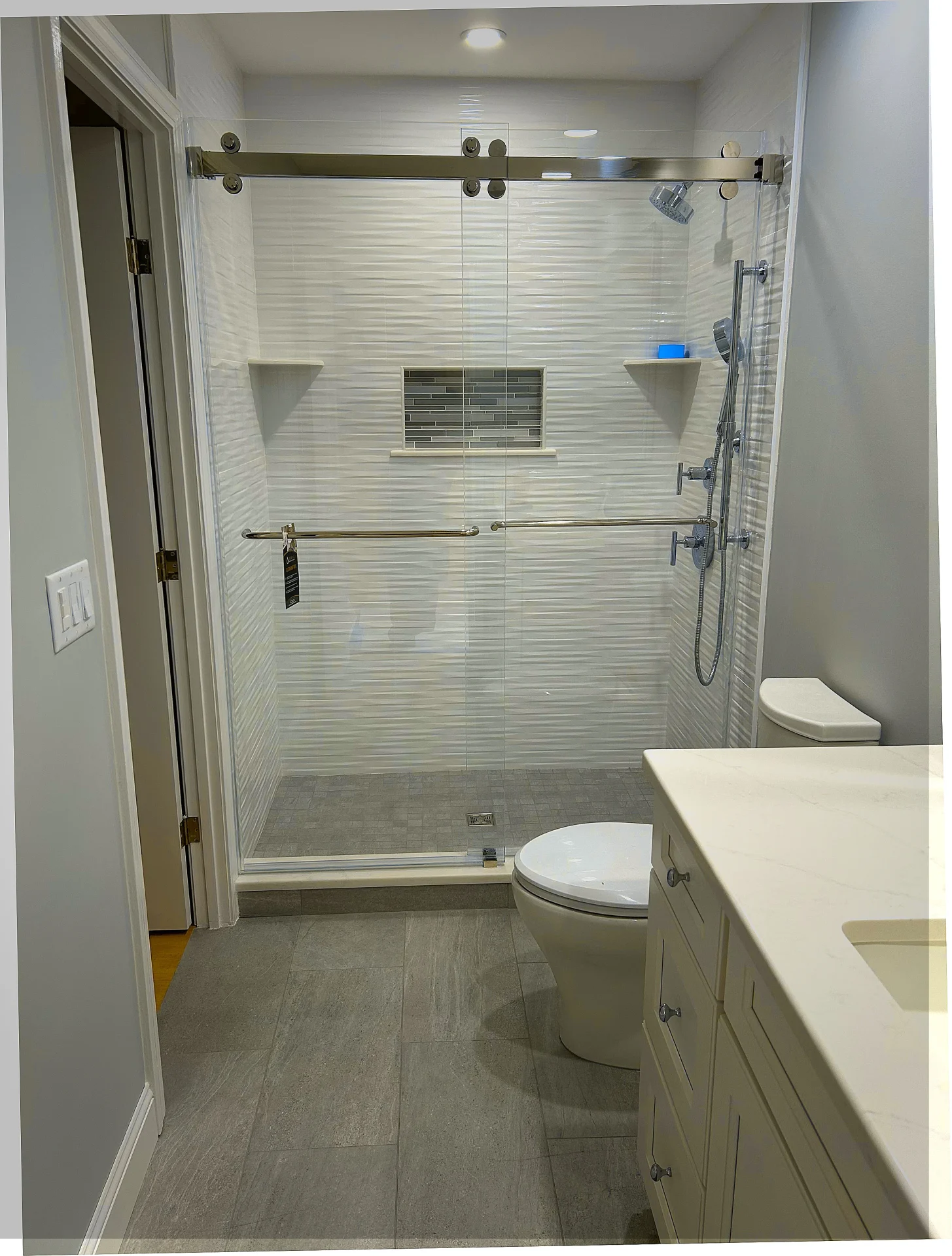 frameless sliding shower enclosure brushed nickel top track textured white tile Peabody MA