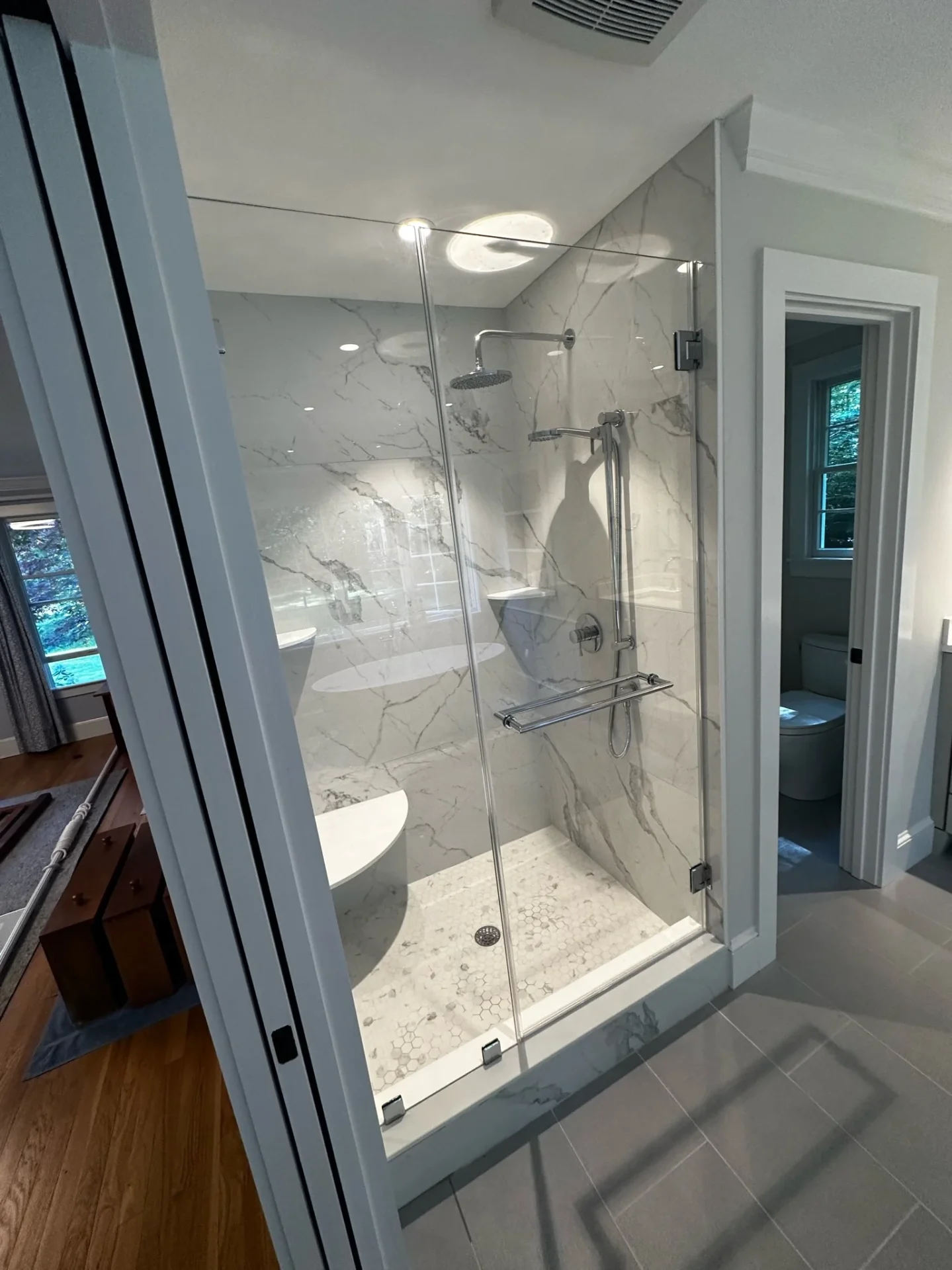 frameless corner shower enclosure chrome hardware Calacatta marble slab Boxford MA