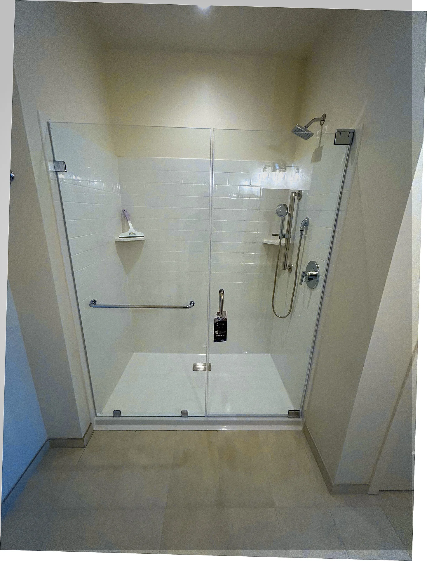 Frameless sliding shower door with polished chrome hardware and white subway tile in Newton MA