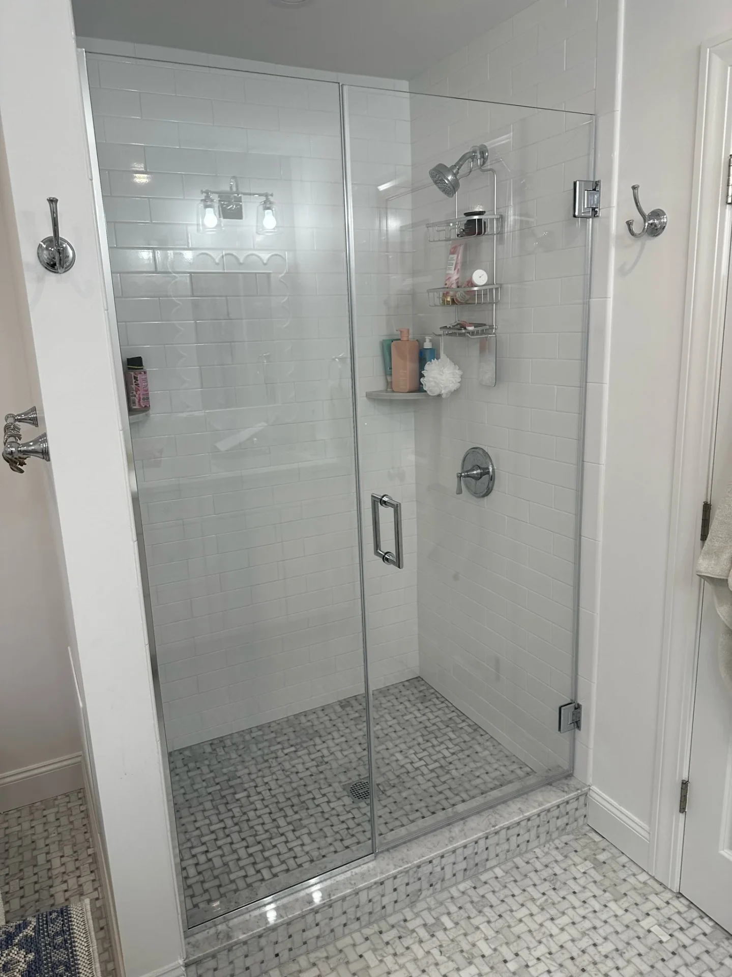 Frameless hinged shower door, chrome hardware, basketweave marble floor, Hamilton MA