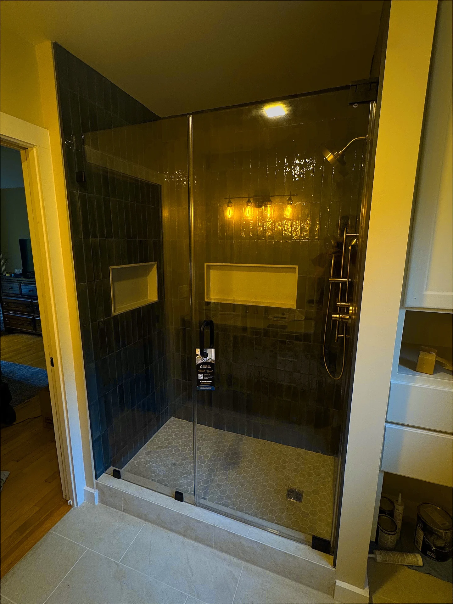 Frameless pivot door matte black hardware dark subway tile Mont Vernon NH