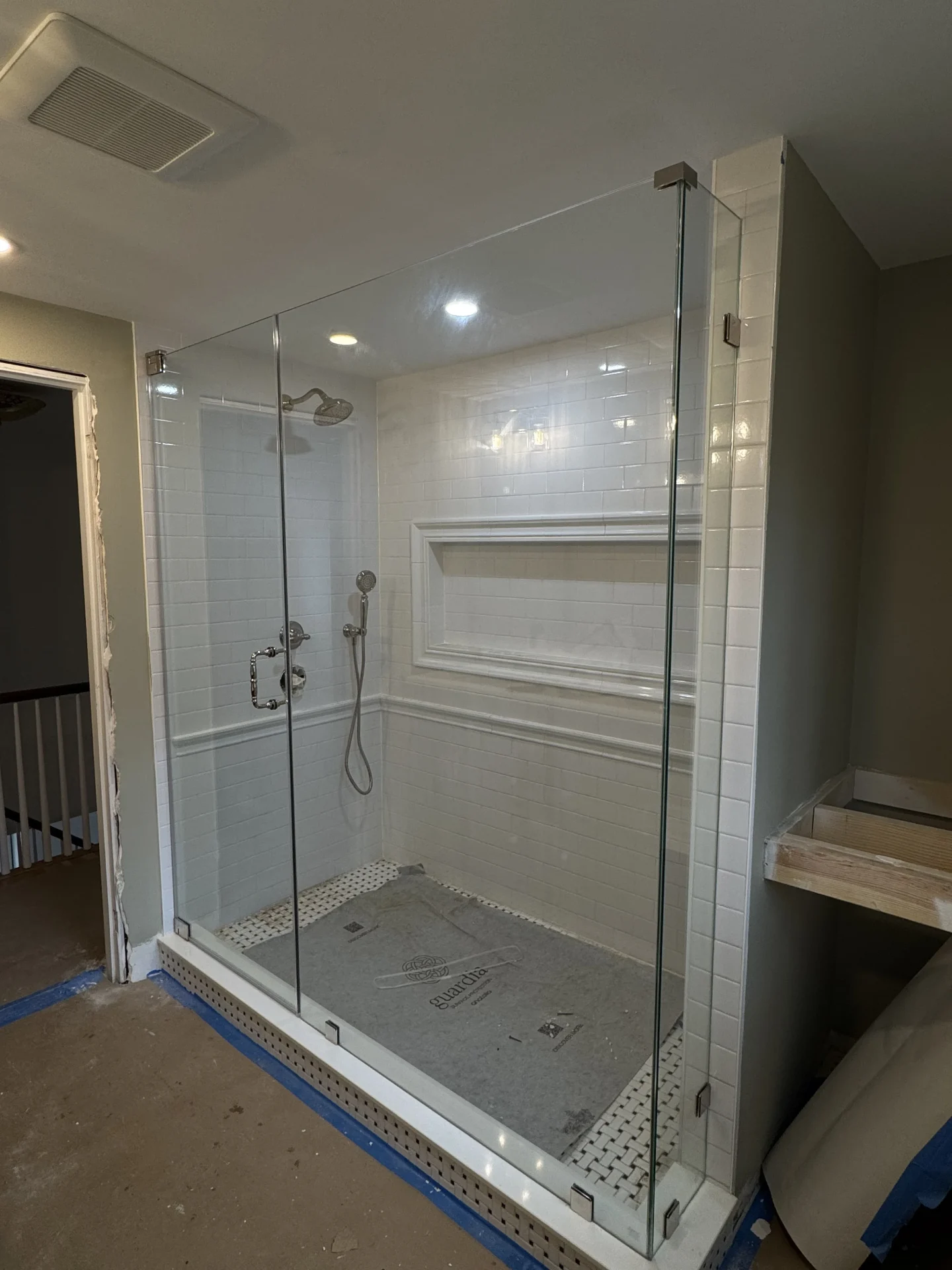 Frameless hinged shower door with chrome hardware, subway tile, Melrose MA