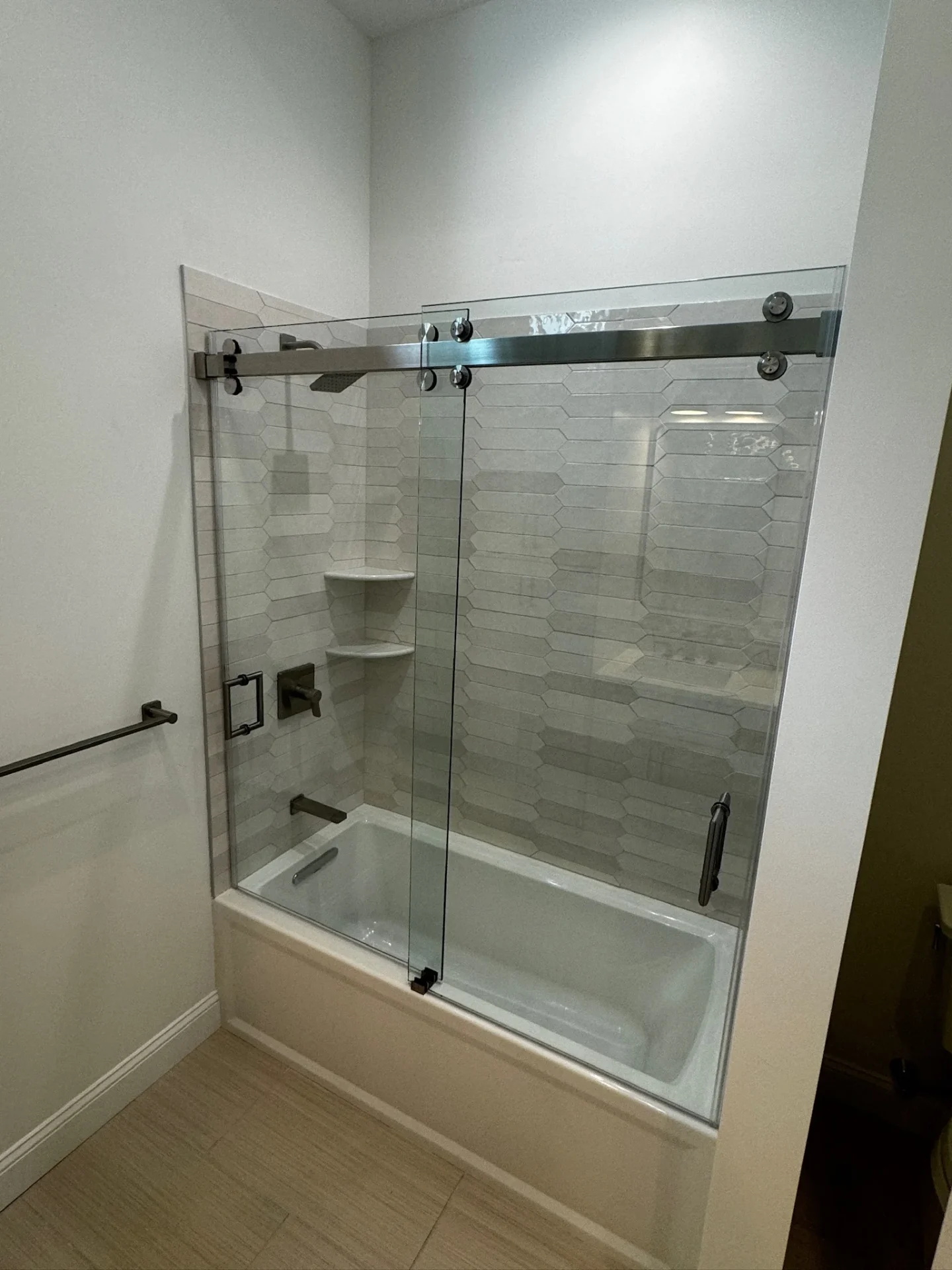 Frameless sliding tub door, stainless track, hexagon tile, Reading MA