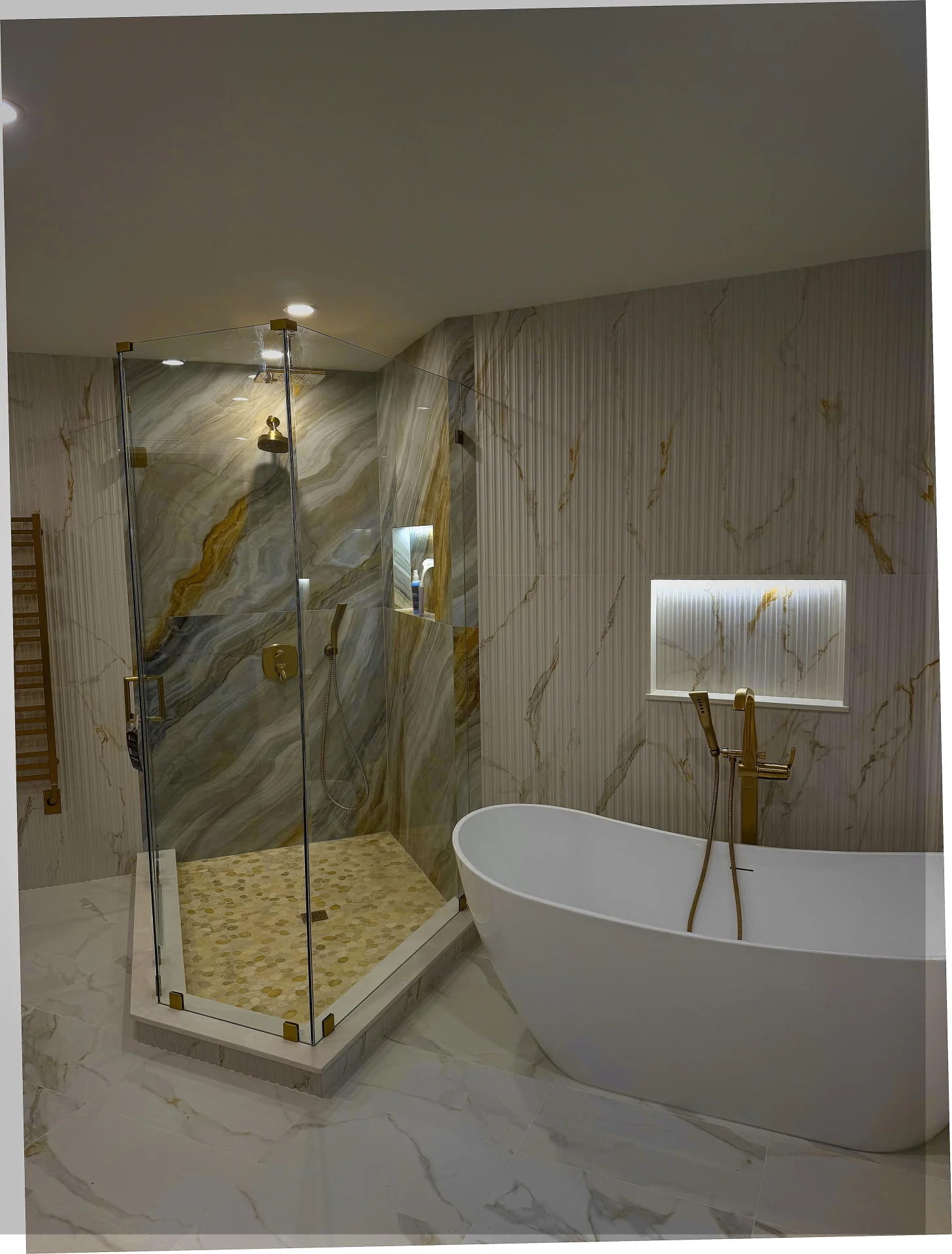 Neo-angle shower door with gold hardware and marble waterfall tile in Andover MA