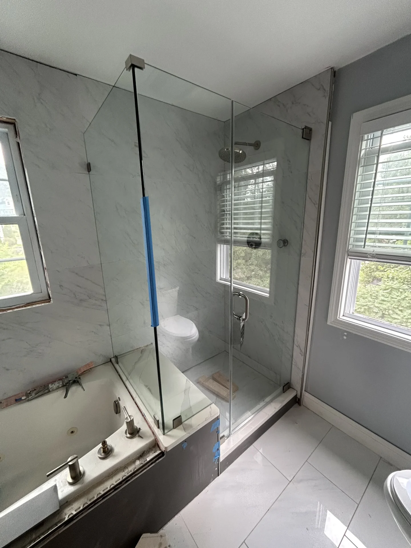 Frameless glass tub and shower combo with brushed nickel hardware, Lynn