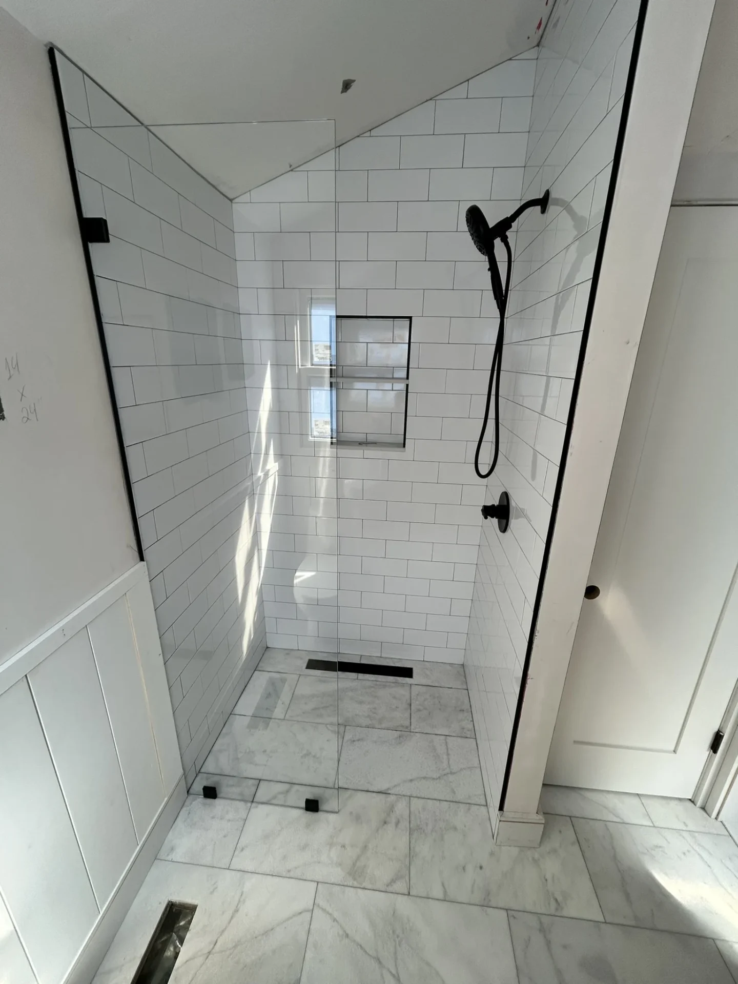 Frameless corner shower door, black hardware, white subway tile, North Andover MA