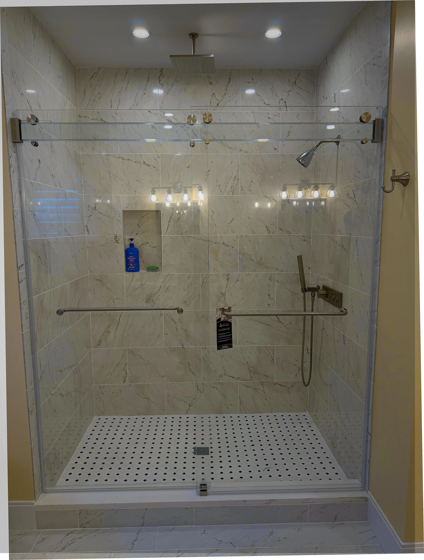 Frameless sliding shower door, brushed nickel hardware, marble mosaic floor, Ipswich MA